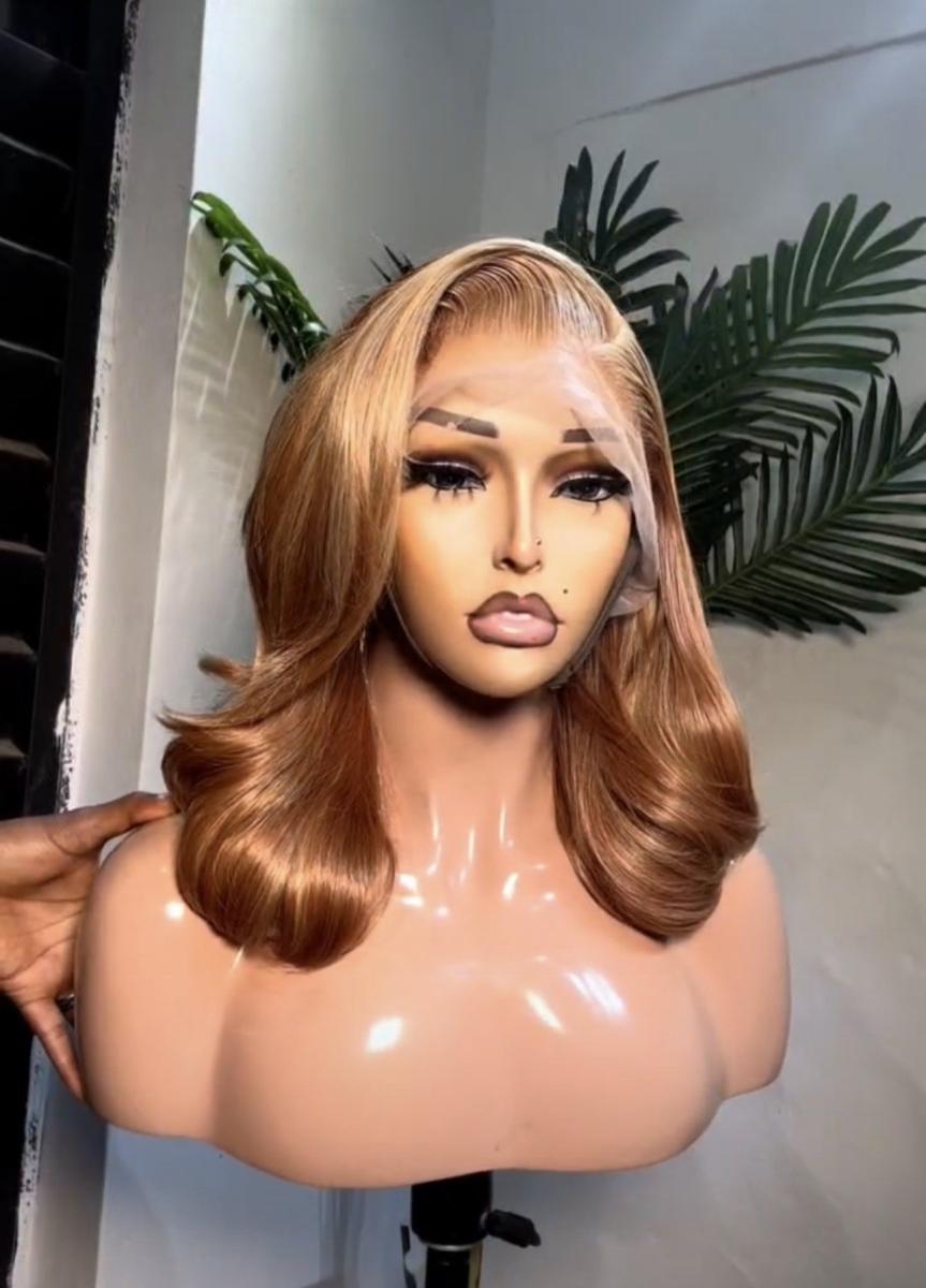 A honey-brown, layered wavy lace frontal wig